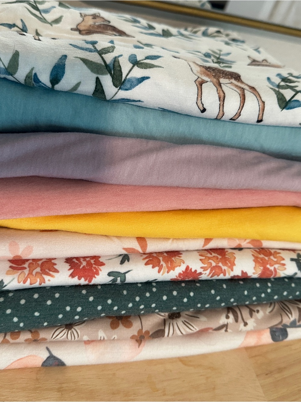 Copper Pearl/Milkmaid Goods swaddle blankets. Floral and solid patterns.